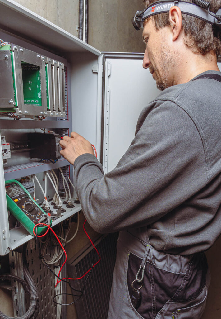 Engineer performing Wind Tunnel Maintenance Resistance Measurements on Tunnel Electronics